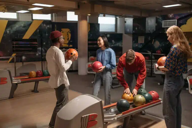 Group of friends enjoying Abu Dhabi nightlife at a vibrant bowling alley