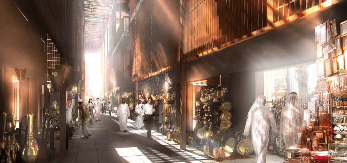 Traditioneller emiratischer Souk in Abu Dhabi mit sonnendurchfluteten Gängen und Marktständen, an denen Messingwaren und handwerkliche Erzeugnisse angeboten werden.