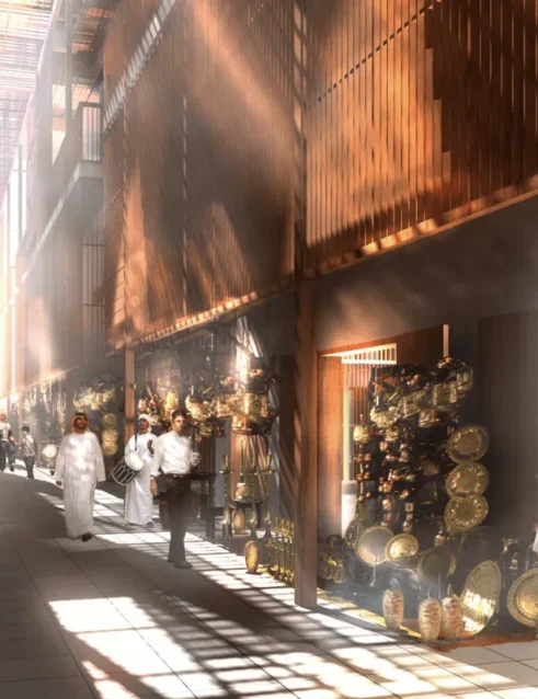 Traditioneller emiratischer Souk in Abu Dhabi mit sonnendurchfluteten Gängen und Marktständen, an denen Messingwaren und handwerkliche Erzeugnisse angeboten werden.