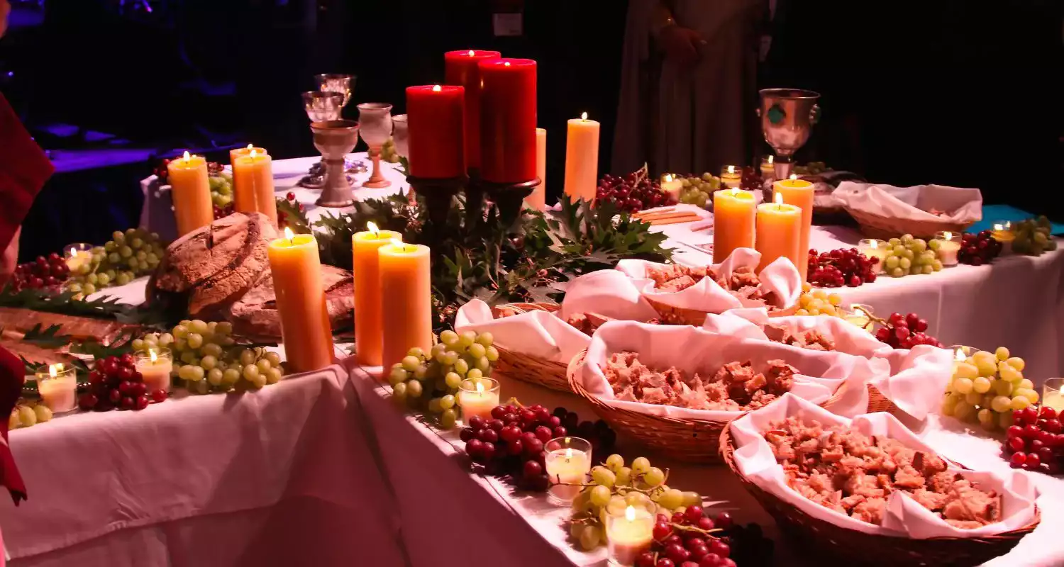 Traditional wedding feast setup with bread, grapes, and candles, representing a cultural Abu Dhabi wedding celebration.